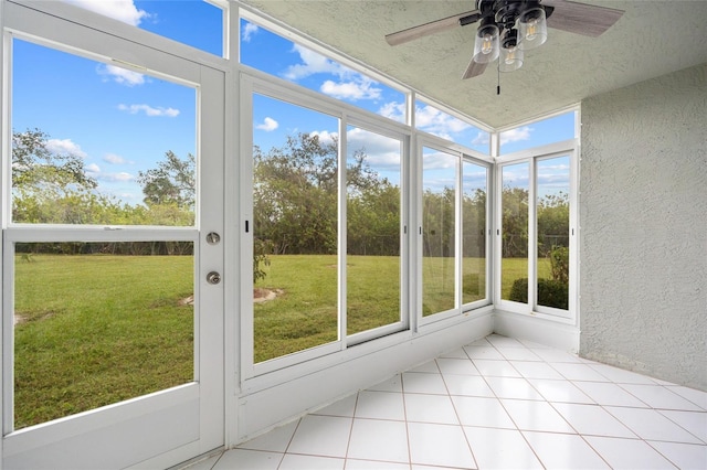 unfurnished sunroom with ceiling fan