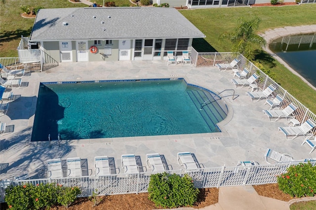 view of swimming pool with a patio area and a water view