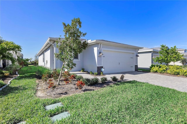 view of front of home featuring a garage and a front lawn