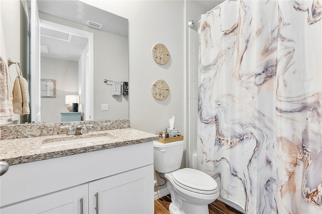 full bathroom featuring vanity, toilet, wood-type flooring, and shower / tub combo