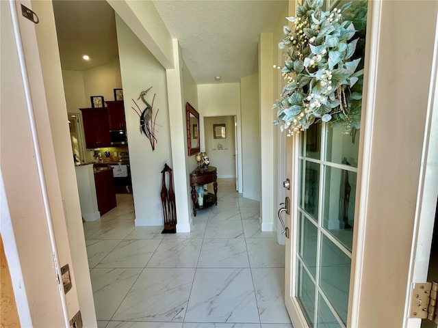 hallway with a textured ceiling