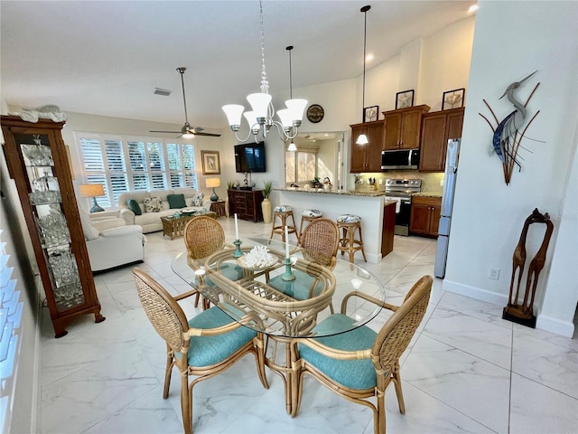 dining room featuring ceiling fan with notable chandelier