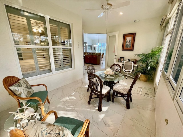 sunroom featuring ceiling fan