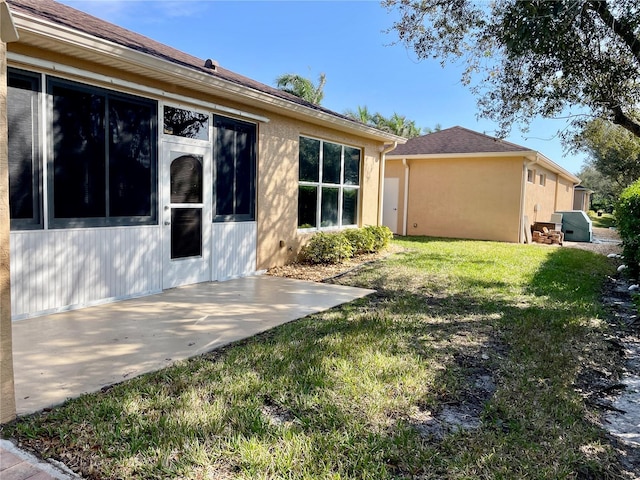 rear view of property featuring a patio area and a yard