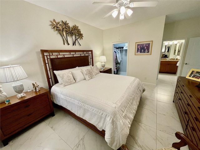 bedroom featuring ceiling fan, ensuite bath, a spacious closet, and a closet