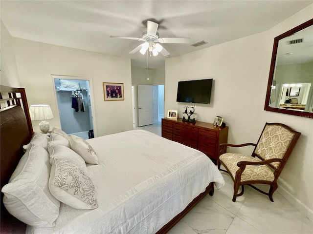 bedroom with a spacious closet, a closet, and ceiling fan