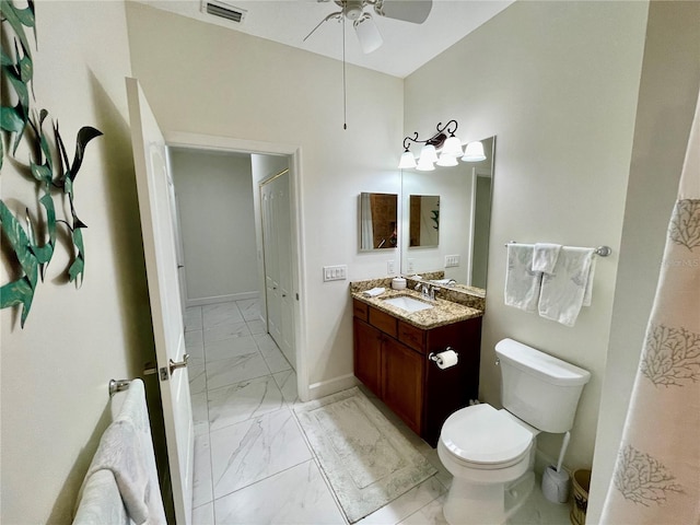 bathroom featuring vanity, toilet, and ceiling fan