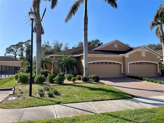 single story home with a front lawn and a garage