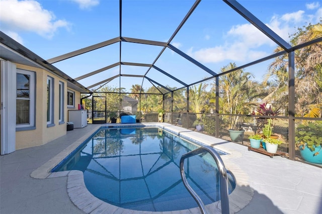 view of pool featuring glass enclosure and a patio