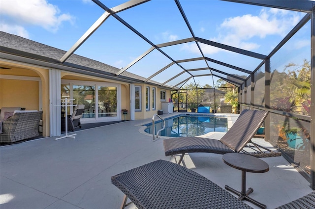 view of swimming pool with a lanai and a patio area