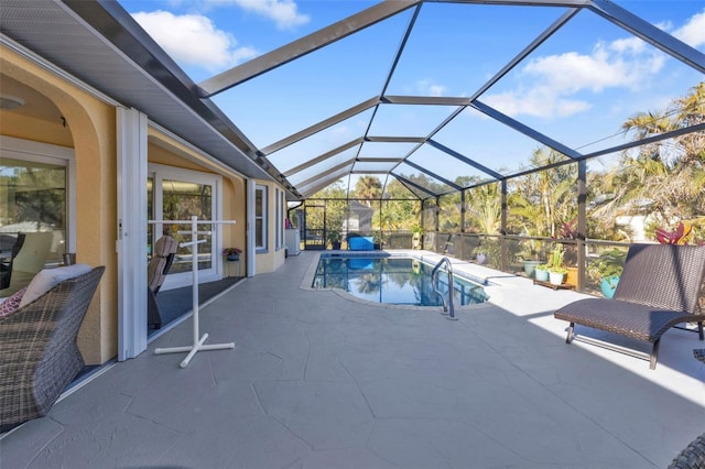 view of pool featuring a patio area and glass enclosure