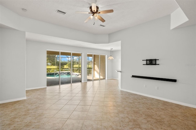 spare room with light tile patterned floors and ceiling fan