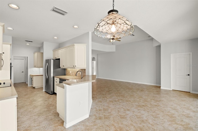 kitchen with kitchen peninsula, black electric stovetop, backsplash, pendant lighting, and light tile patterned floors