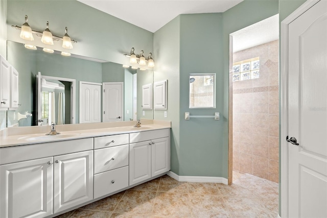 bathroom featuring tile patterned floors, vanity, and a shower