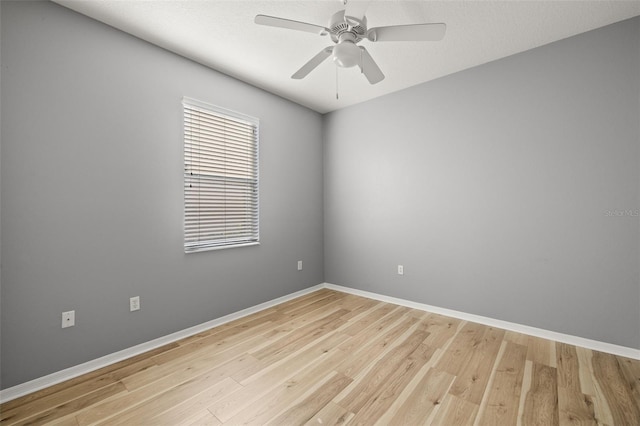 spare room featuring ceiling fan and light hardwood / wood-style flooring