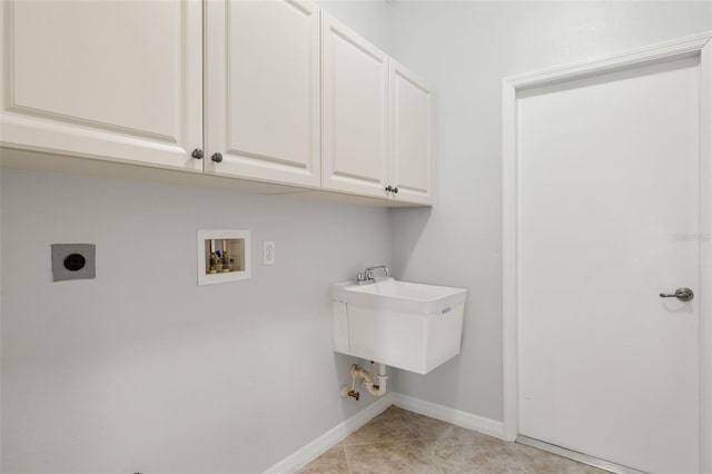 clothes washing area featuring cabinets, sink, washer hookup, light tile patterned floors, and hookup for an electric dryer