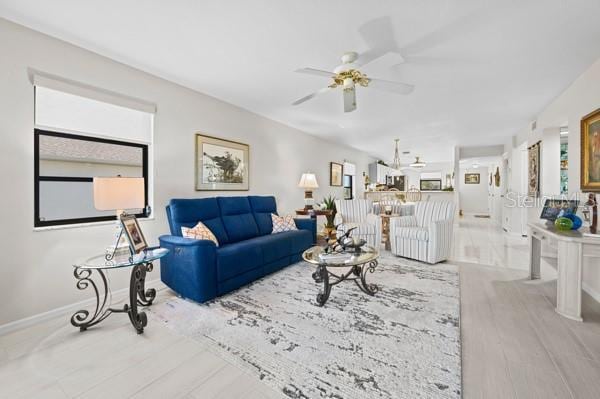 living room with ceiling fan and light hardwood / wood-style floors