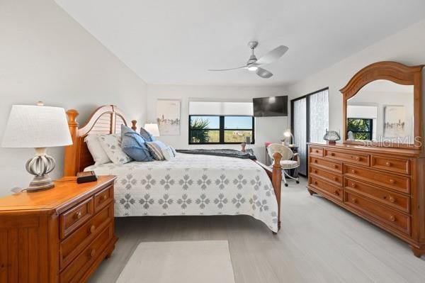 bedroom with ceiling fan and light wood-type flooring