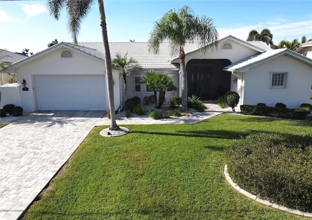 ranch-style home with a garage and a front yard