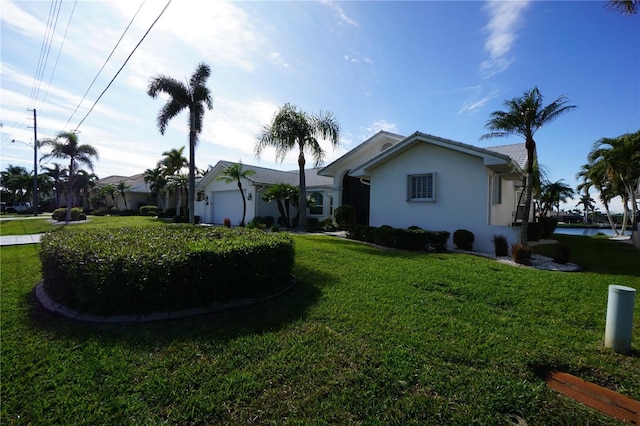 exterior space featuring a garage and a front lawn