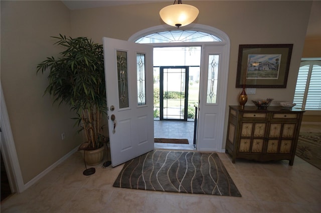 foyer entrance with light tile patterned floors