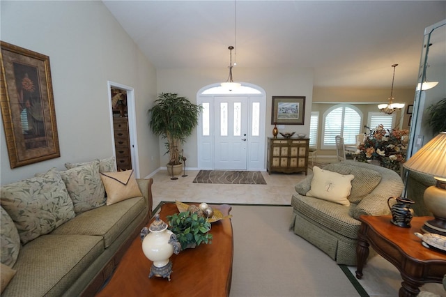 living room with light colored carpet, a healthy amount of sunlight, and a notable chandelier