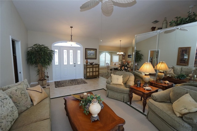 living room featuring ceiling fan with notable chandelier