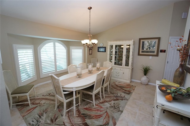 tiled dining area featuring a chandelier, a healthy amount of sunlight, and lofted ceiling