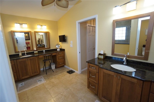 bathroom with ceiling fan, toilet, vanity, and vaulted ceiling