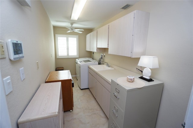 clothes washing area with cabinets, sink, ceiling fan, independent washer and dryer, and light tile patterned flooring