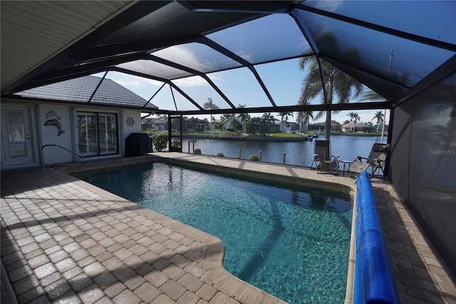 view of swimming pool featuring a lanai, a patio area, and a water view