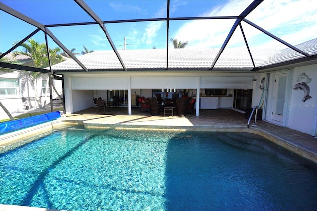 view of swimming pool featuring a patio area and glass enclosure