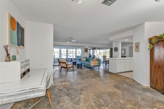 living room featuring concrete floors and ceiling fan