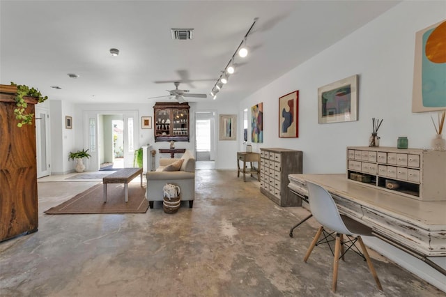 living room featuring ceiling fan, concrete floors, and track lighting