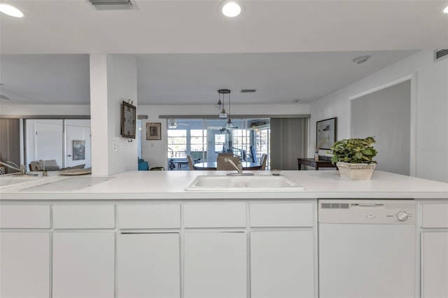 kitchen with white cabinets, pendant lighting, white dishwasher, and sink