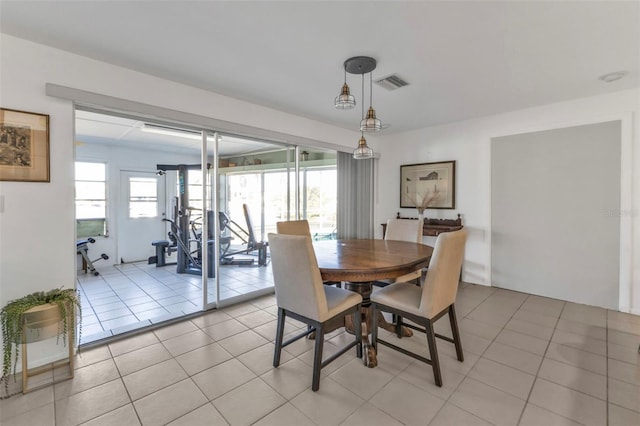 dining room with a wealth of natural light and light tile patterned floors