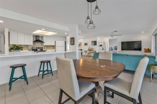 dining area featuring ceiling fan and light tile patterned floors