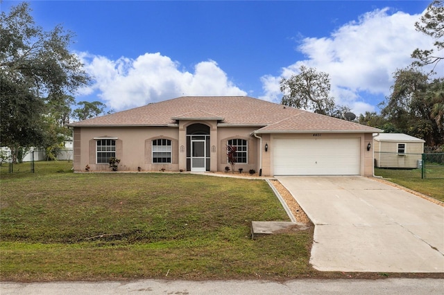 view of front of house featuring a front lawn and a garage