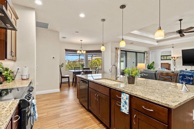 kitchen featuring sink, dishwasher, hanging light fixtures, range with electric stovetop, and a raised ceiling