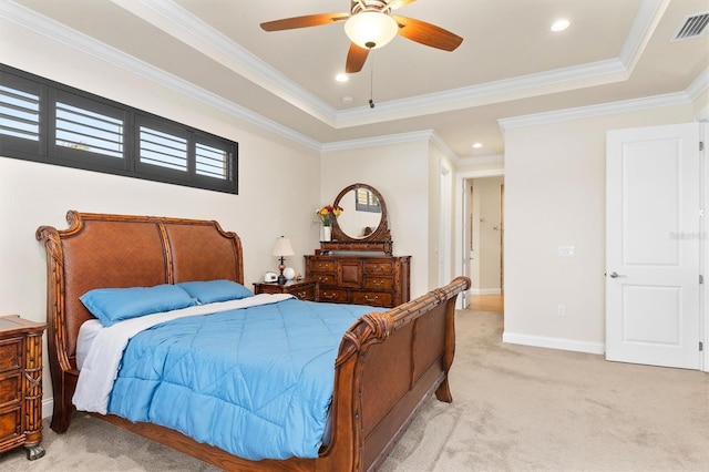 carpeted bedroom featuring ceiling fan, ornamental molding, and a raised ceiling