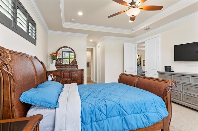 bedroom featuring crown molding, a tray ceiling, light colored carpet, and ceiling fan