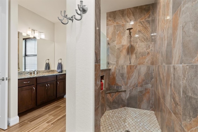 bathroom with vanity and tiled shower