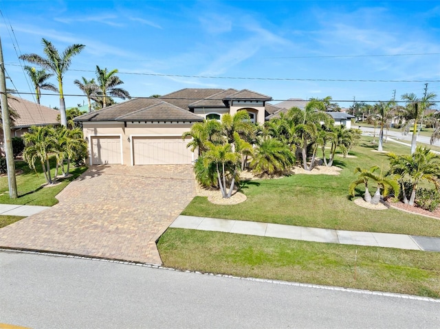 view of front of property featuring a garage and a front yard