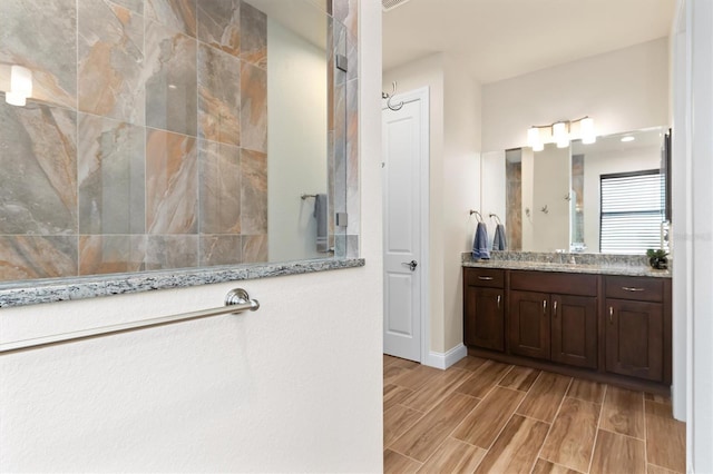 bathroom featuring vanity and a shower