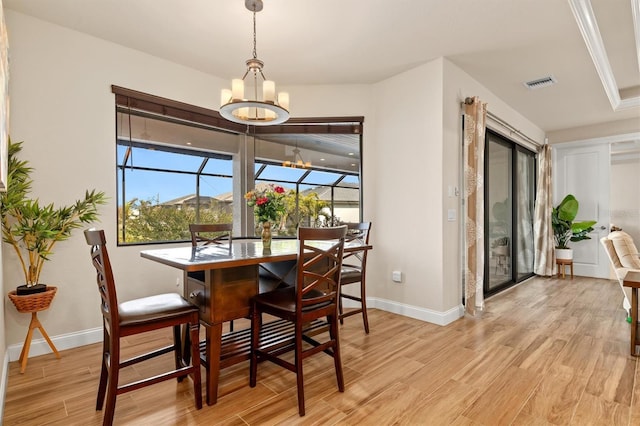 dining room with a chandelier and light wood-type flooring