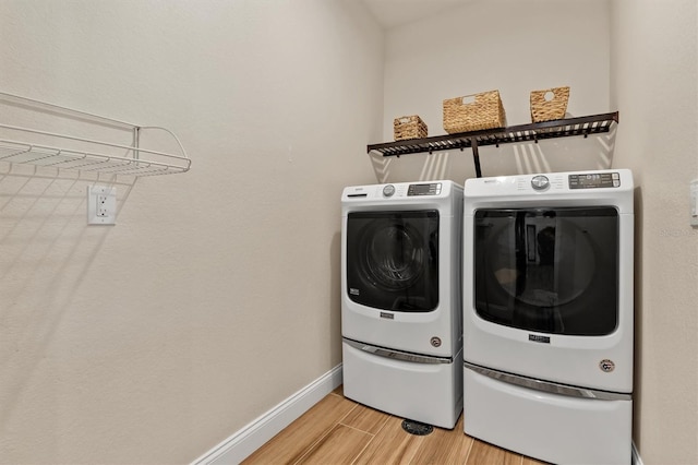 laundry area featuring separate washer and dryer and wood-type flooring