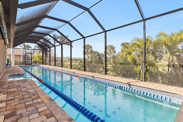 view of swimming pool with a patio area and glass enclosure