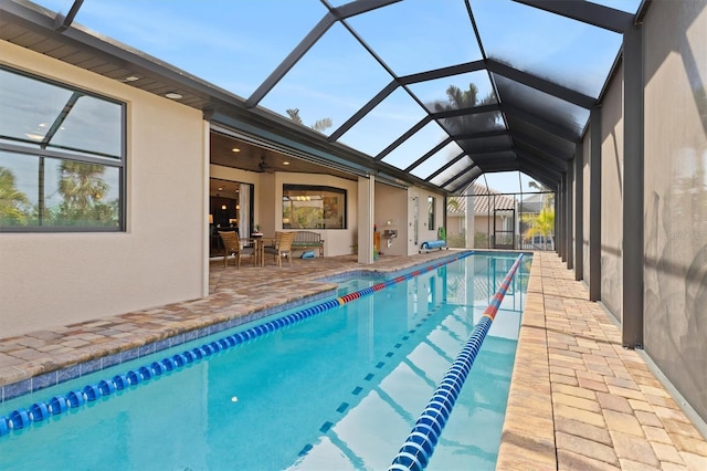 view of pool featuring ceiling fan, a lanai, and a patio area