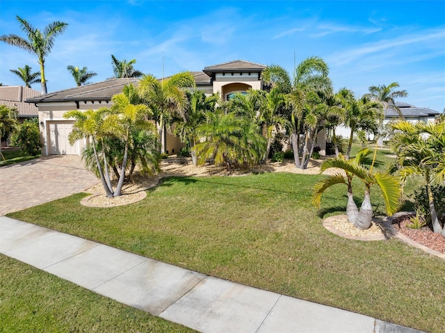 view of front of house with a garage and a front yard