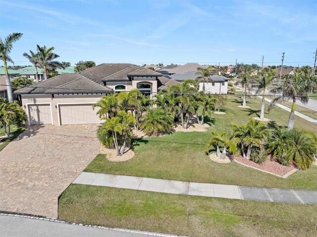 view of front of property featuring a garage and a front yard